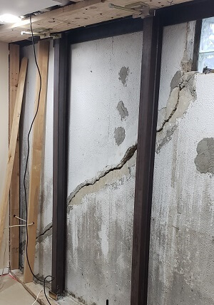 customer testimonial picture: a severely cracked and bowing basement wall fixed by Gorilla Wall Braces