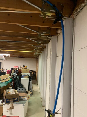 photo of a customer installation of Gorilla Wall Braces that fixed their bowing basement wall