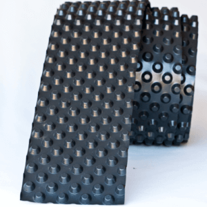 A "dimpled" waterproofing membrane made from High Density Polyethylene (HDPE) black plastic.