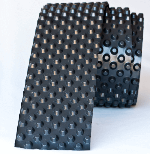 A "dimpled" waterproofing membrane made from High Density Polyethylene (HDPE) black plastic.