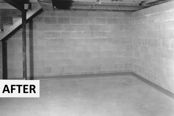 an AFTER picture of a formerly wet basement with the DRY-UP baseboard diy kit installed - block walls are now dry and basement waterproofed